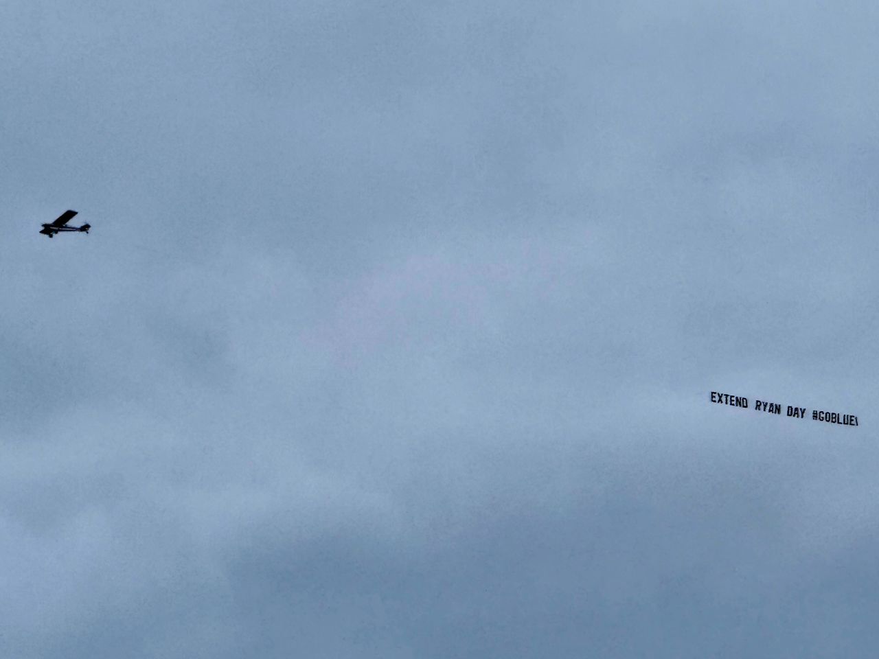 A plane flies a banner reading "Extend Ryan Day #GoBlue" in Columbus, Ohio.