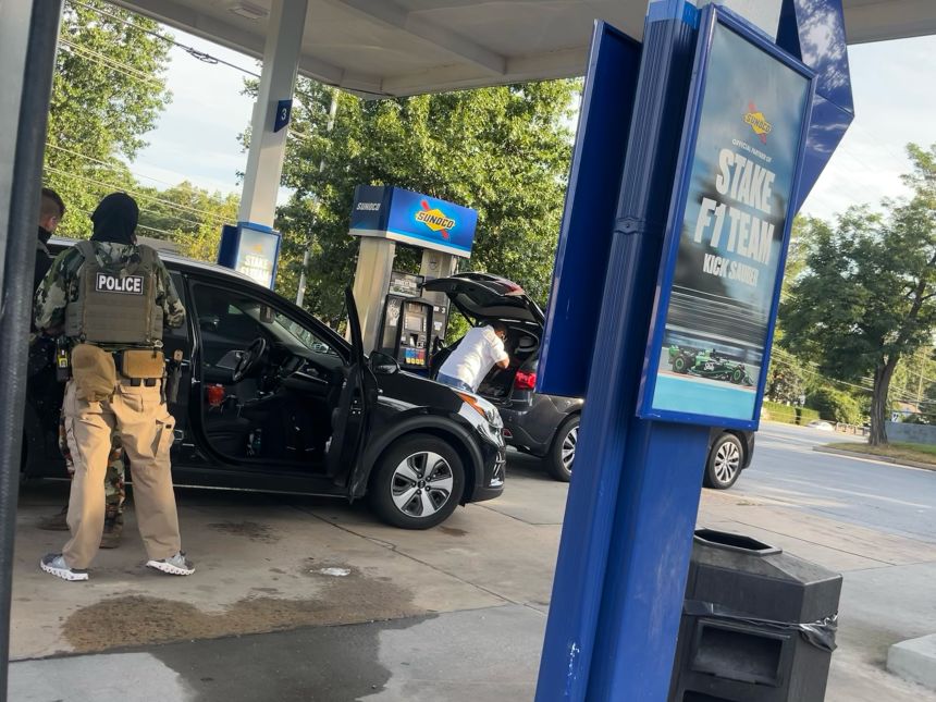 ICE agents apprehend a man at a gas station just outside Washington, DC.