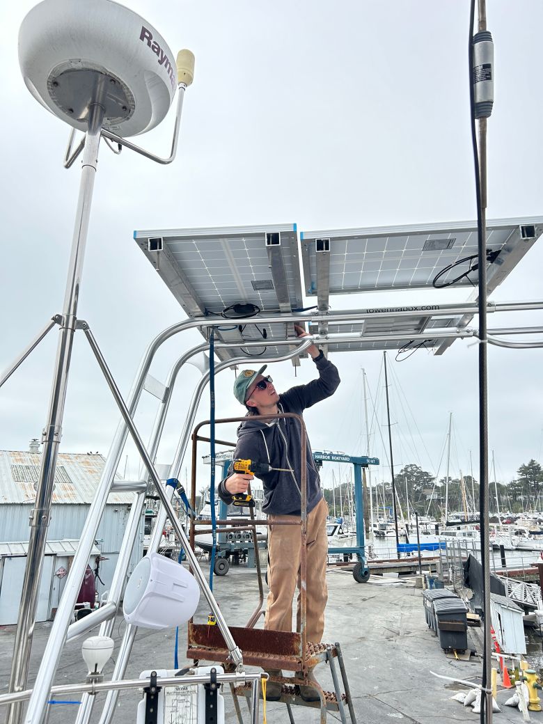 Jack Elliott, in December 2024, working on the boat. The friends did most of the work themselves, crowdsourcing advice from more experienced sailors.