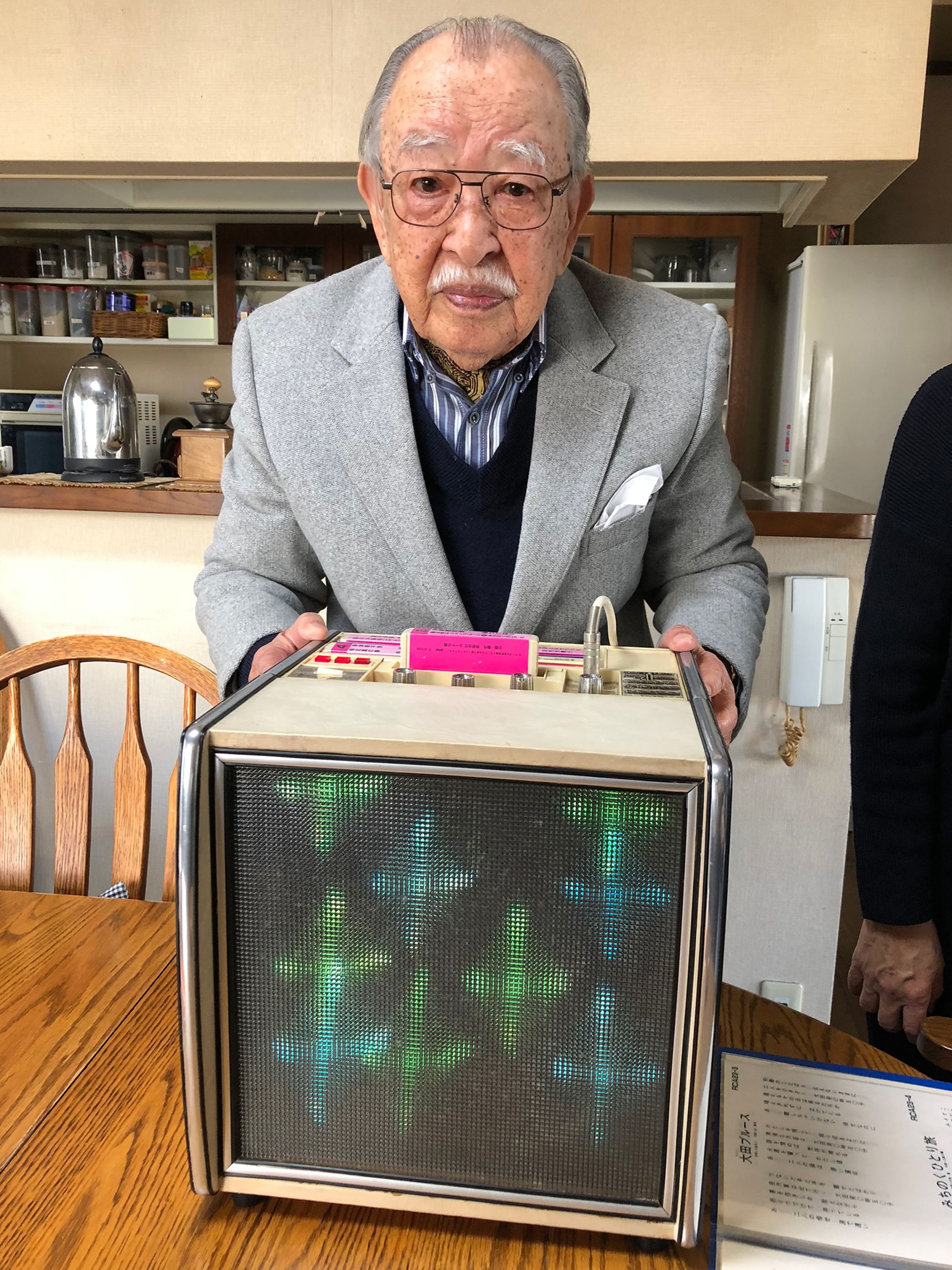 Shigeichi Negishi, inventor of the earliest karaoke machine, poses with his creation for a picture featured in author Matt Alt's book, “Pure Invention: How Japan Made the Modern World."