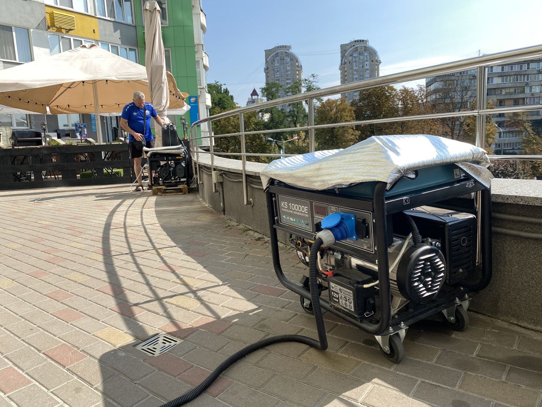 Restaurant workers put out generators during a blackout in the Ukrainian capital on August 27.