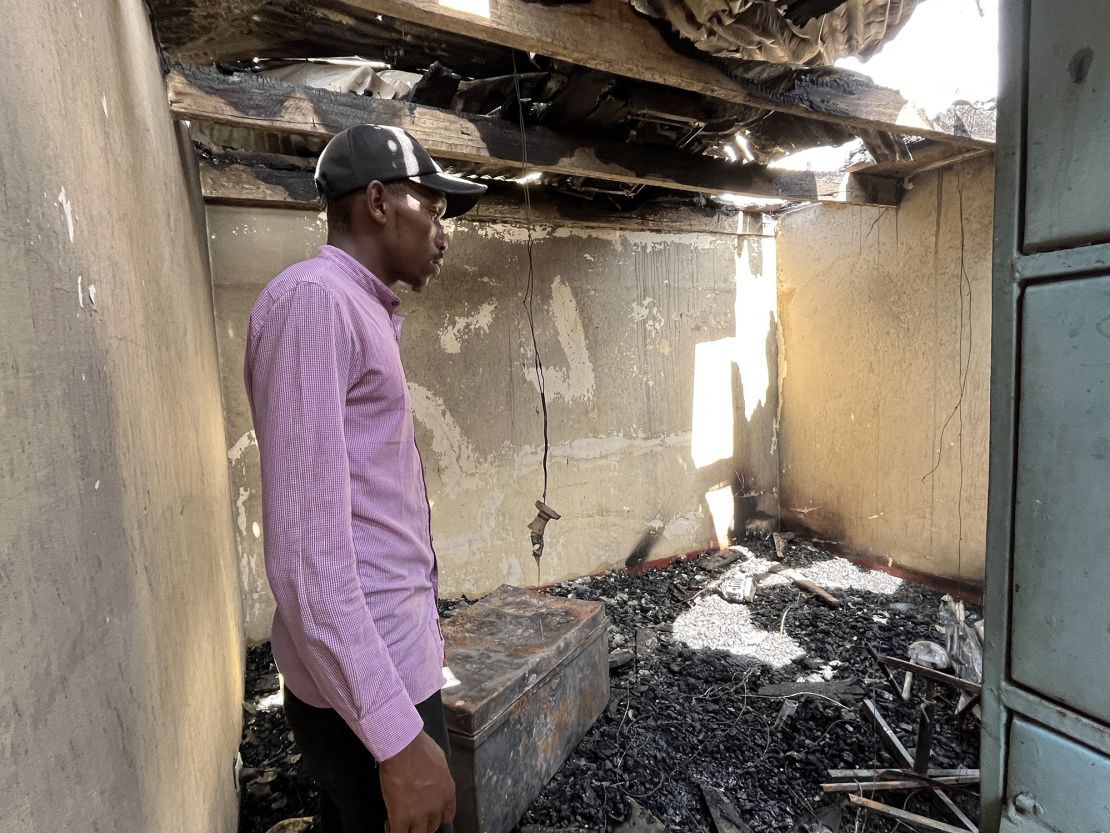 Alex Ontita looks over his wrecked home.