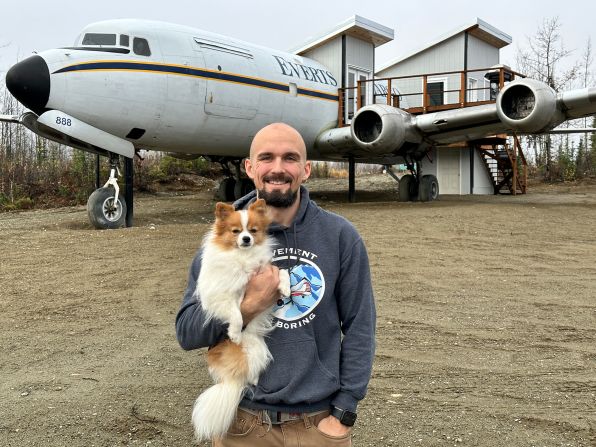 <strong>Jon Kotwicki and Foxtrot: </strong>Flight instructor Jon Kotwicki -- pictured with his Pomeranian dog Foxtrot -- is developing his own airport and pilot lodge in Alaska. The McDonnell Douglas DC-6 plane behind him has been converted to accommodation.