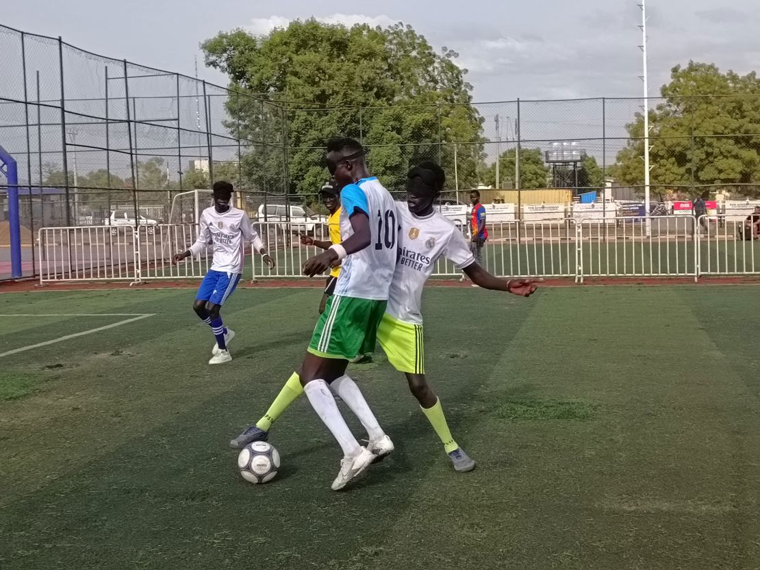 Two players tussle for the ball during a game.