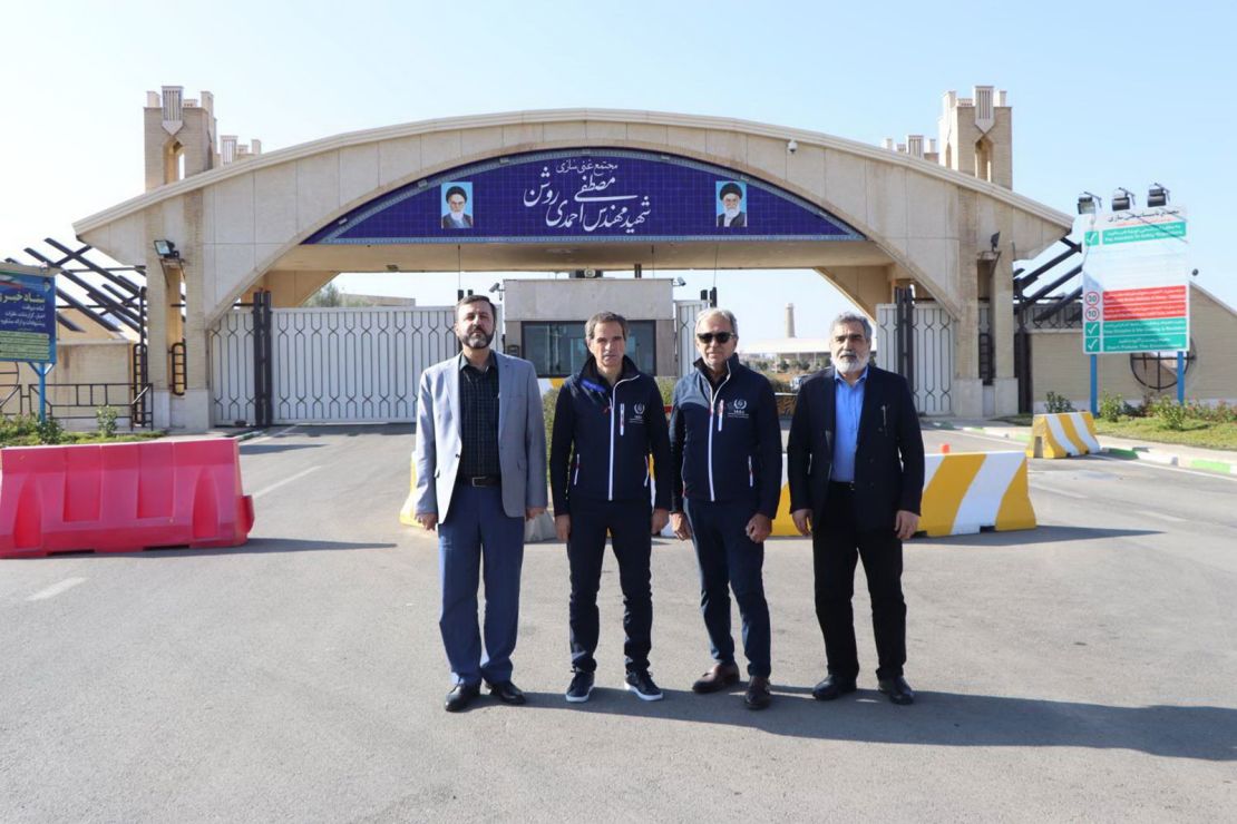 This handout picture provided by the Atomic Energy Organisation of Iran on November 15, 2024 shows the organization's spokesman Behrouz Kamalvandi, right, and Iran's Deputy Foreign Minister Kazem Gharib Abadi, left, posing for a picture with the International Atomic Energy Agency (IAEA) chief Rafael Grossi, second left, in front of the gate of the Fordow nuclear enrichment plant, near the city of Qom.