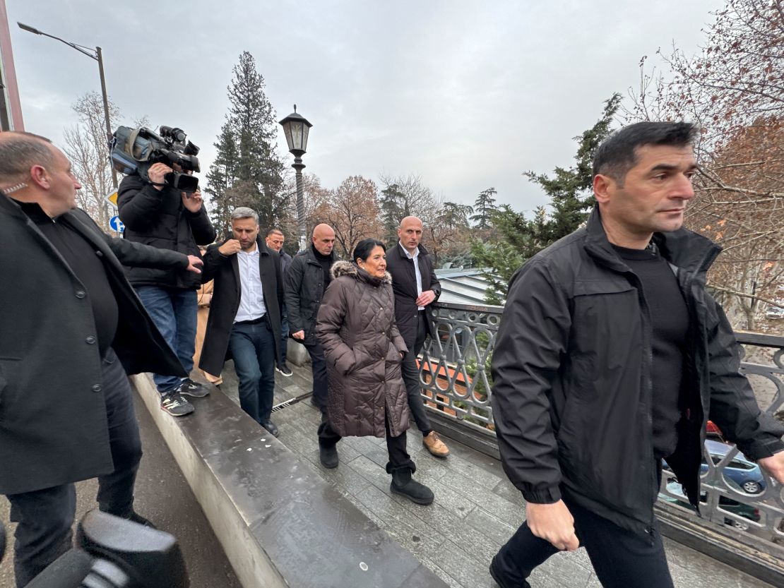 Georgian President Salome Zourabichvili walks to the presidential palace Saturday after greeting supporters in Tbilisi.