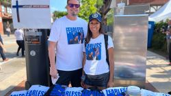 Brad and Andrea Neuser pose with their merchandise being sold outside of the Republican National Convention in Milwaukee, Wisconsin.