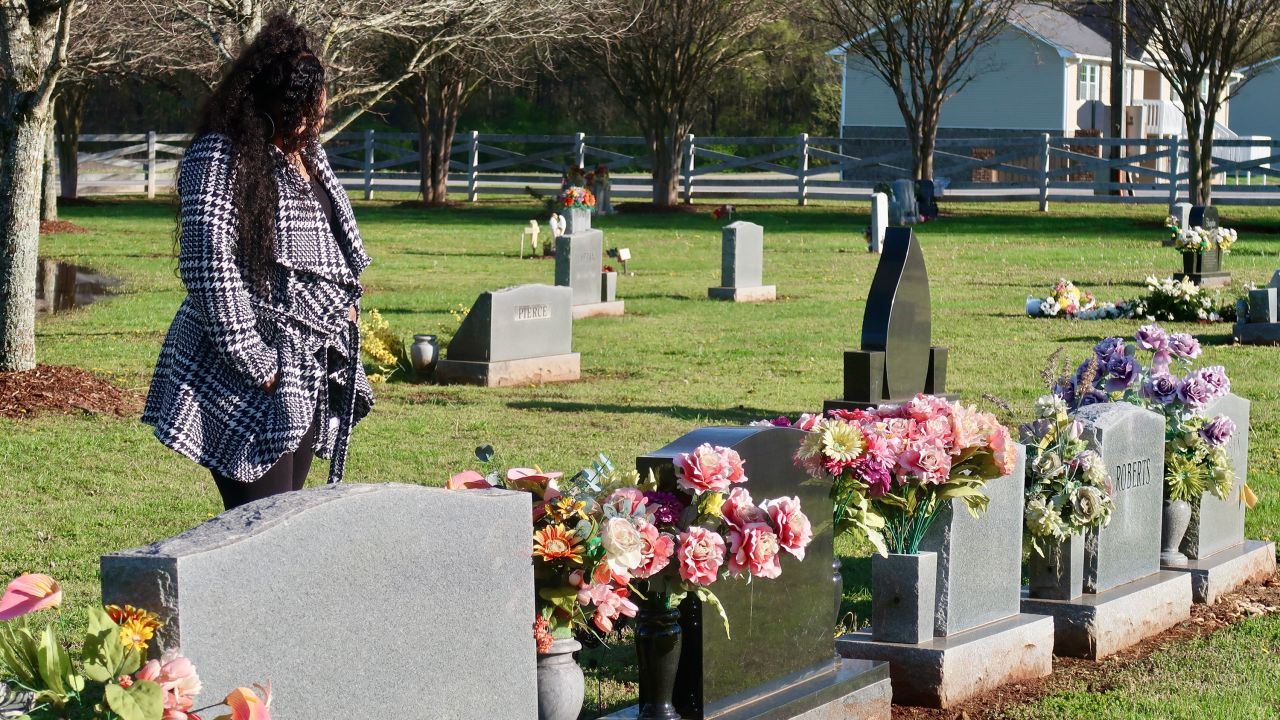 Camika Shelby visits the grave of her son.