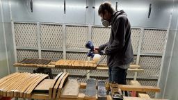 Michael Prieto, owner of Barrel-Art, spraying a clear coat finish on products in his shop in Newport News, Virginia, on November 13.