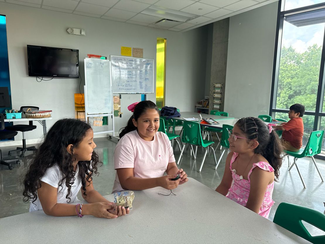 Students Monserrat (left), April (center) and Allison (right) take a break at summer camp.