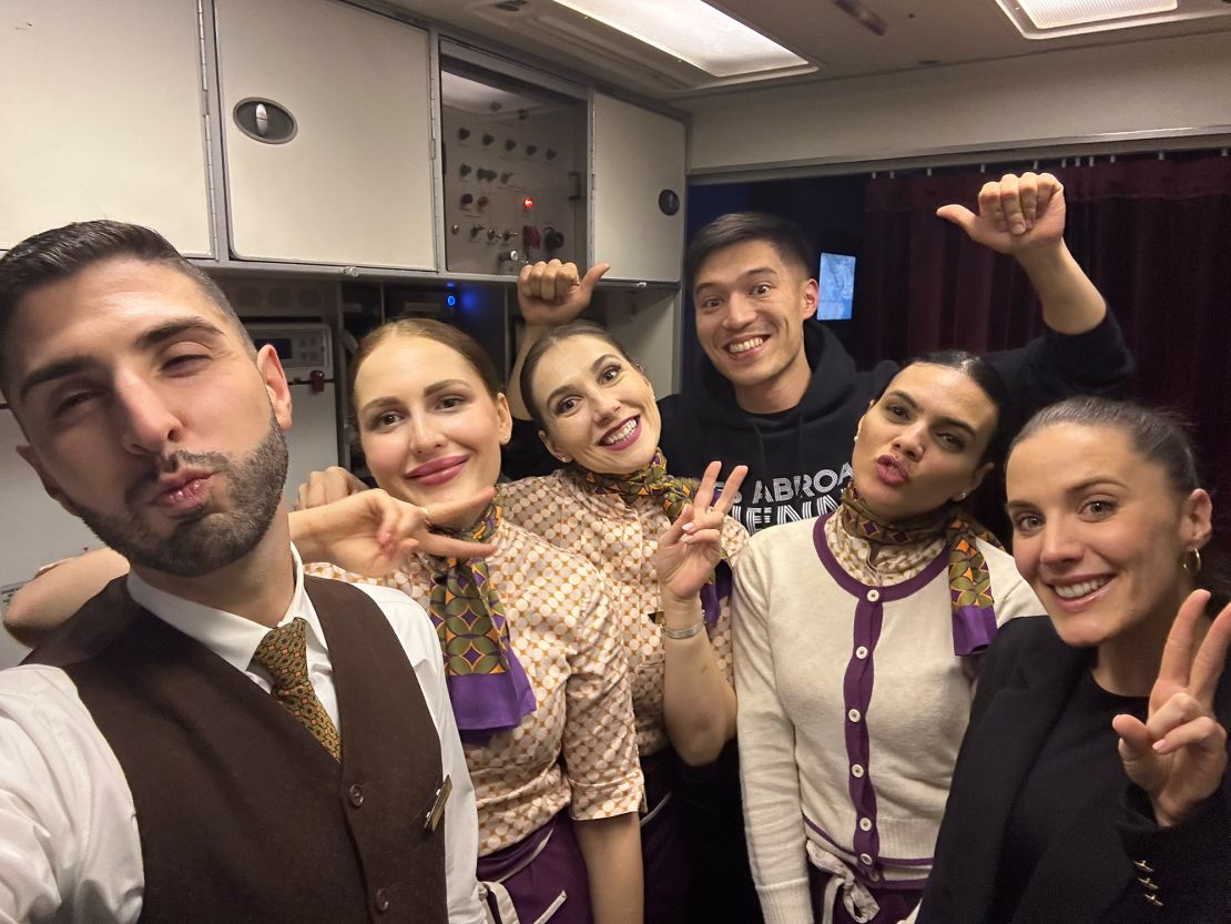 Beleza, seen posing with cabin crew during a flight, speaks five languages fluently.