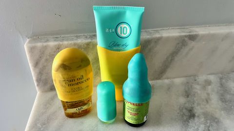 A photo of four bottles covered by elastic toiletry sleeves