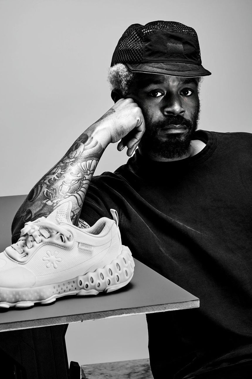 Salehe Bembury poses with a Spunge Osmosis sneaker, the first model launched by the new brand.