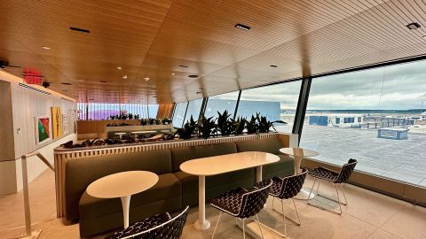 A photo of a dining area with booth-style seats at the Capital One Lounge at Washington-Dulles International Airport (IAD)