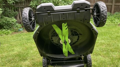 Ego Power mower, tipped on rear wheels to display dual blade setup.