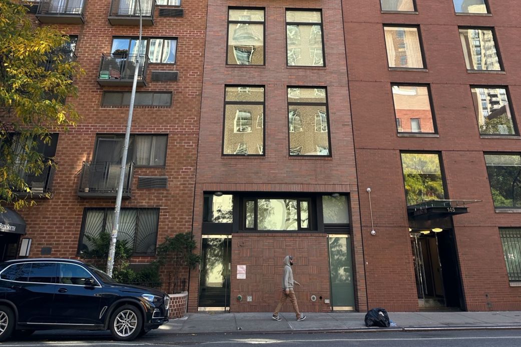 A person walks by a Kip's Bay apartment where investigators say an illegal poker operation unfolded.