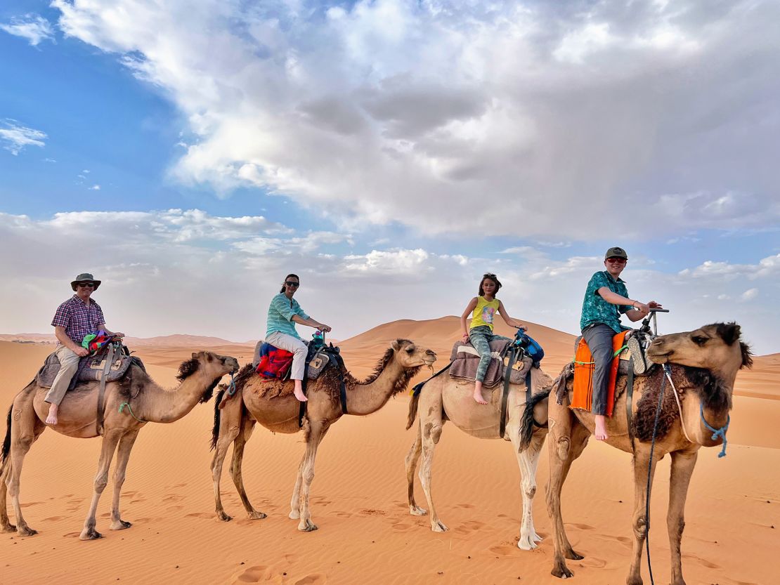 The family rode camels in the Sahara desert in Morocco.