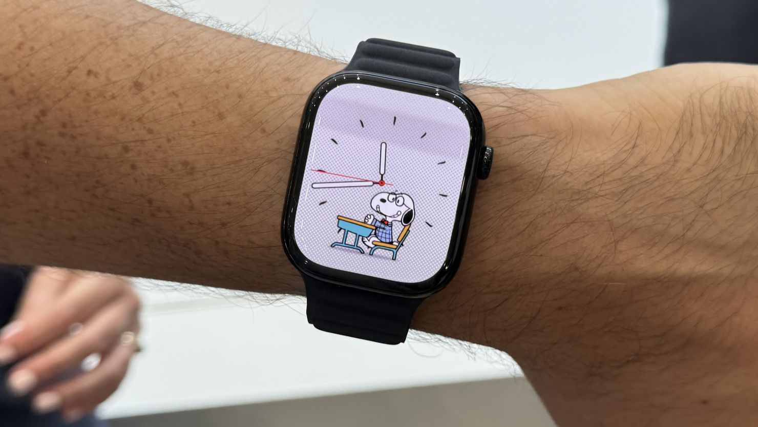 The Apple Watch Series 10 with a Snoopy watch face on a wrist