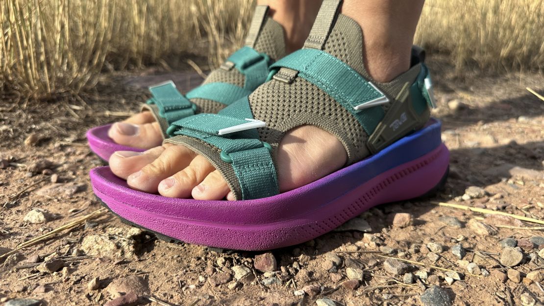 Side view of feet wearing Teva Aventrail sandals.