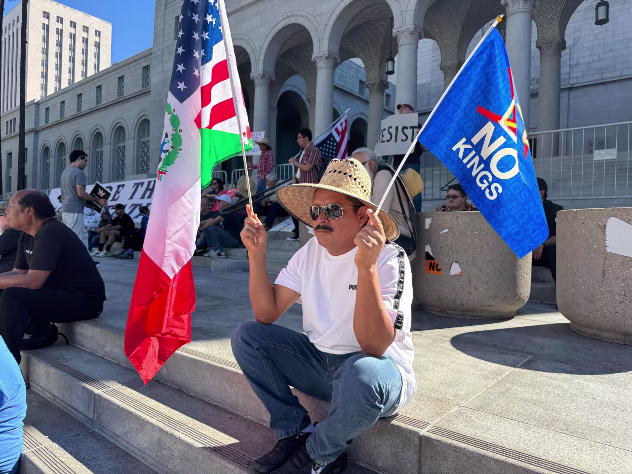 People gather around Los Angeles City Hall ahead of a "No Kings" protest Saturday.