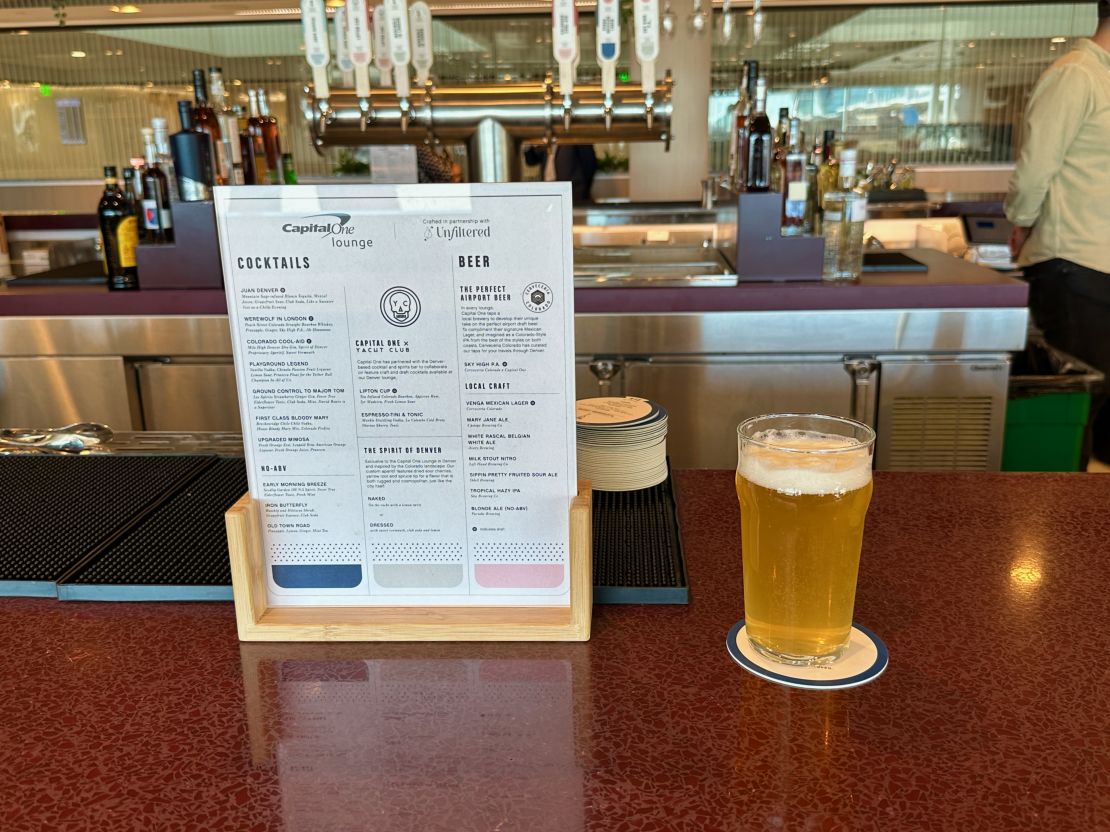 A photo of a beer and the bar menu at the Capital One Lounge in Denver