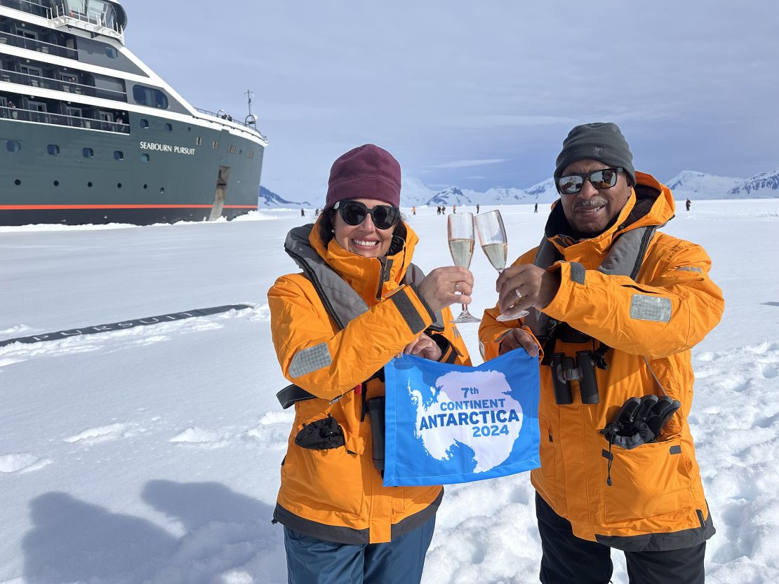 Susana and Greg McCurdy celebrate a walk on a floating Antarctic ice sheet.