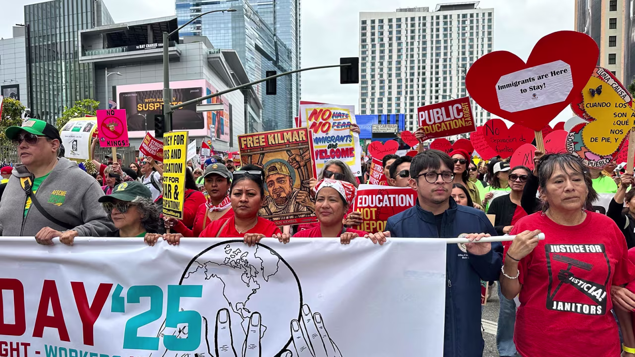 Protesters hold up various signs and banners demanding Kilmar Abrego Garcia to be brought back to the US during a protest on Thursday, in Los Angeles.