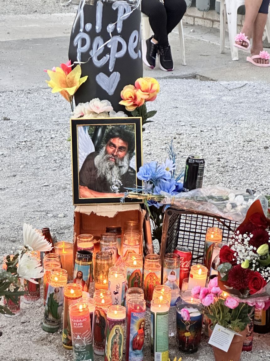 Community members set up a makeshift memorial of candles and flowers near the spot where 