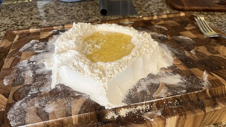 A mixture of egg and flour form the early stages of pasta dough.