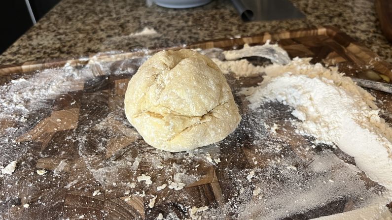 An incomplete pasta dough ball that still requires kneading.