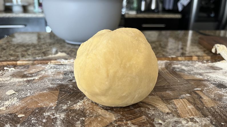 A ball of pasta dough that's ready to be rolled flat.