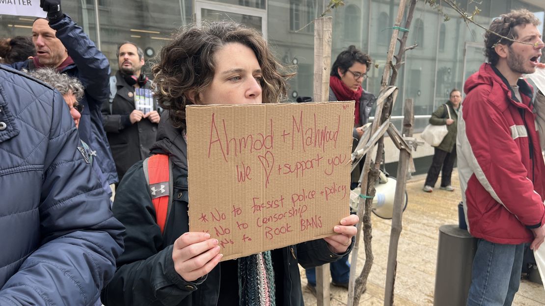 Protesters holding signs in front of a courthouse after the Educational Bookshop was raided by Israeli police and its owners arrested.