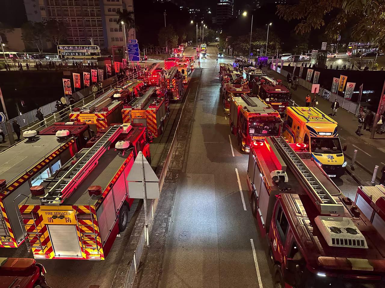 Firefighters and emergency services at the site of a fire engulfing residential buildings at Wang Fuk Court.