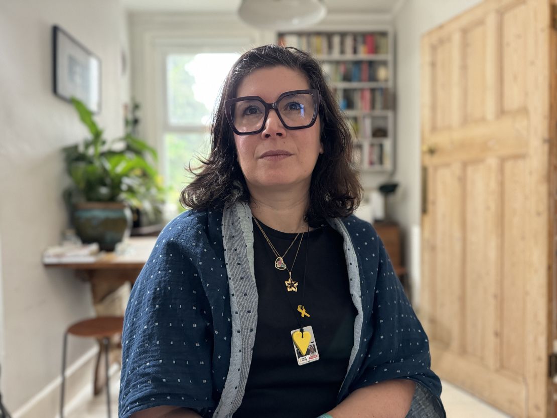 Sharone Lifschitz, pictured at her home in London, wears a dog tag around her neck engraved with her father Oded's age, 84, and the message 