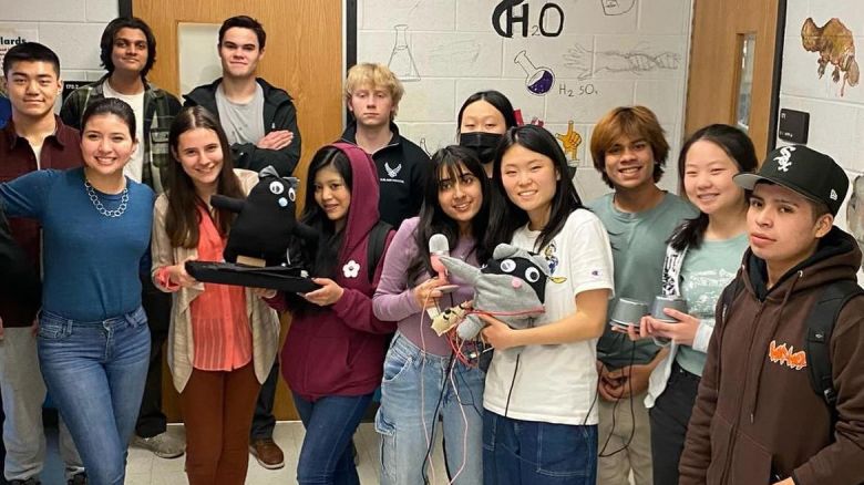 Princeton High School students hold their AI-powered robot.