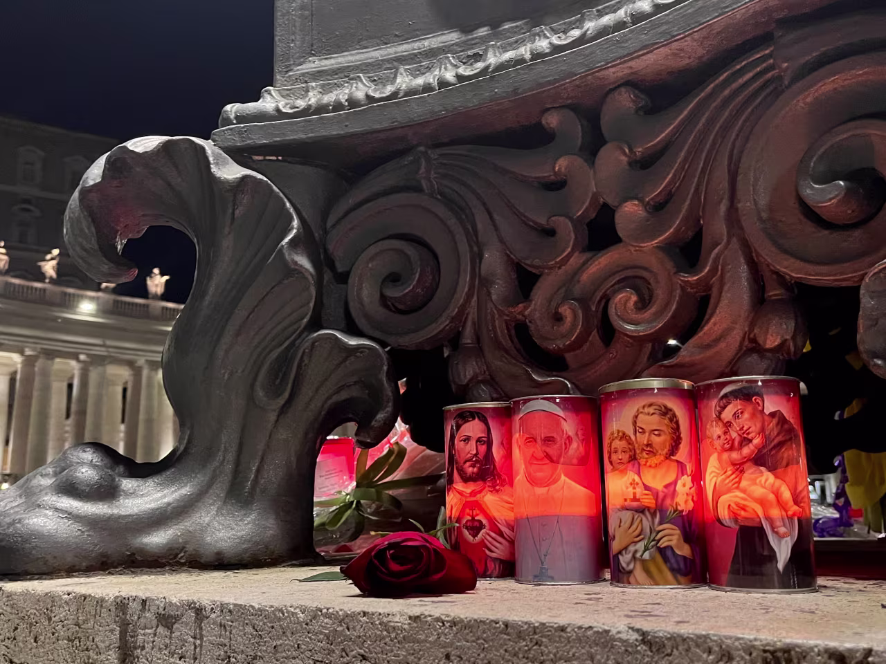 Candles lit by a monument in St. Peter's square.