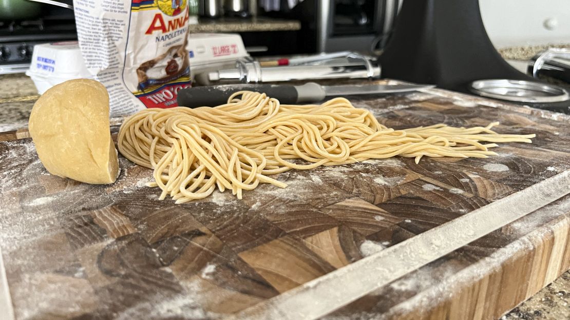 Freshly cut spaghetti on a cutting board before it is cooked.