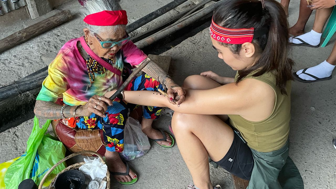 Kathleen Magramo gets tattooed by Whang Od.
