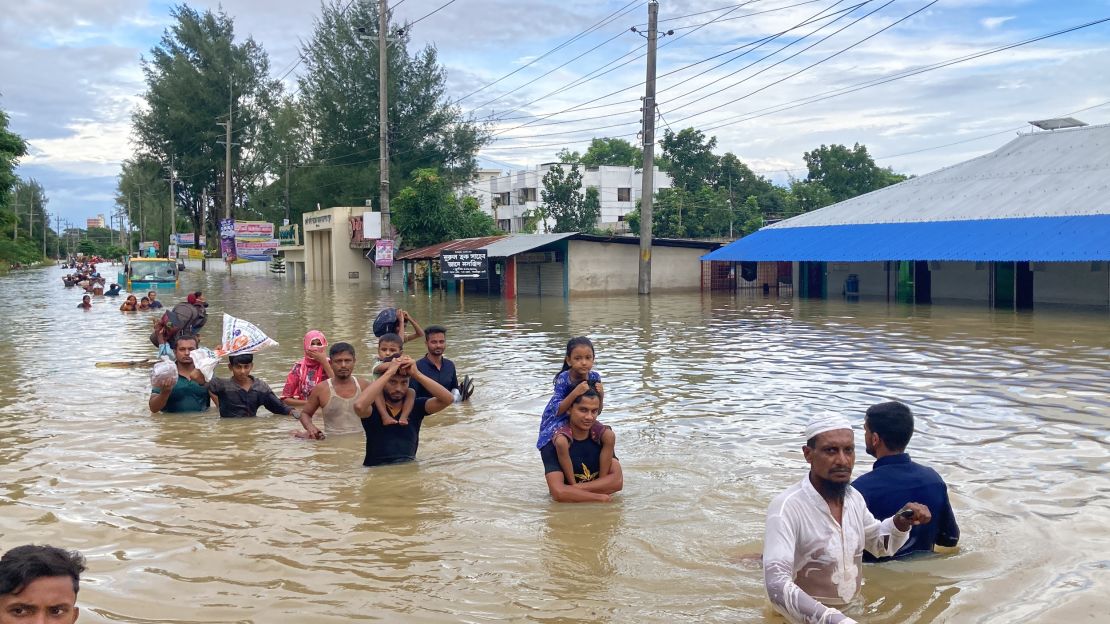 Residents of Feni in Bangladesh walk to higher ground after severe flooding.