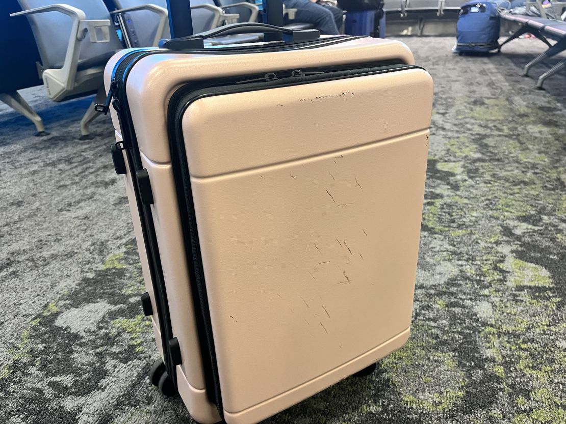 Calpack Hue front pocket carry-on in airport