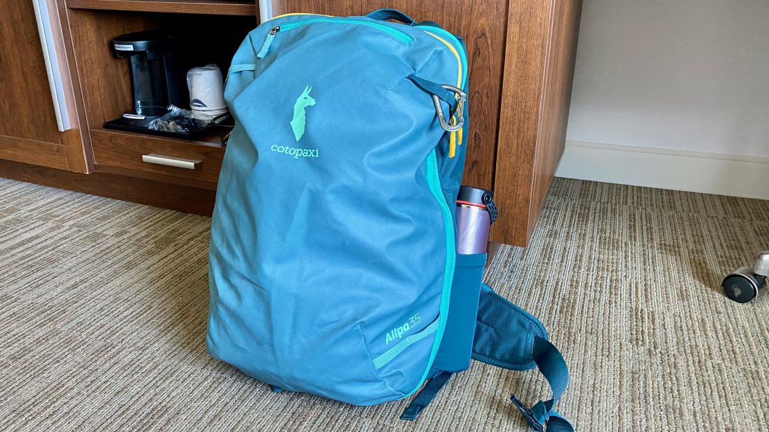 A photo of the redesigned Cotopaxi Allpa 35L Travel Pack on the floor of a hotel room