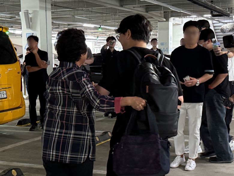 Workers who had been detained by ICE in Georgia reunite with their loved ones after arriving back at Incheon International Airport in Incheon, South Korea, on September 12, 2025.
