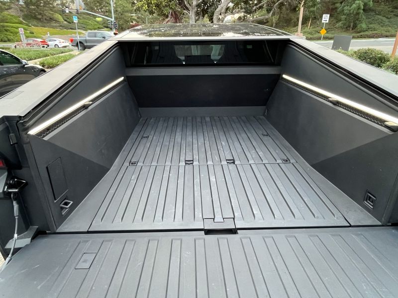 The Tesla Cybertruck has an awkwardly shaped bed that hampers its use. There is also a storage bin under the bed floor, though.