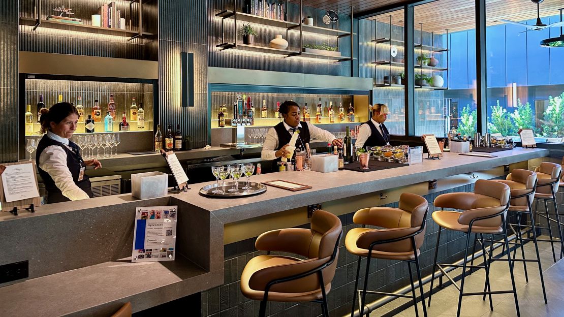 A photo of bartenders making cocktails at the Atlanta Centurion Lounge's whiskey bar