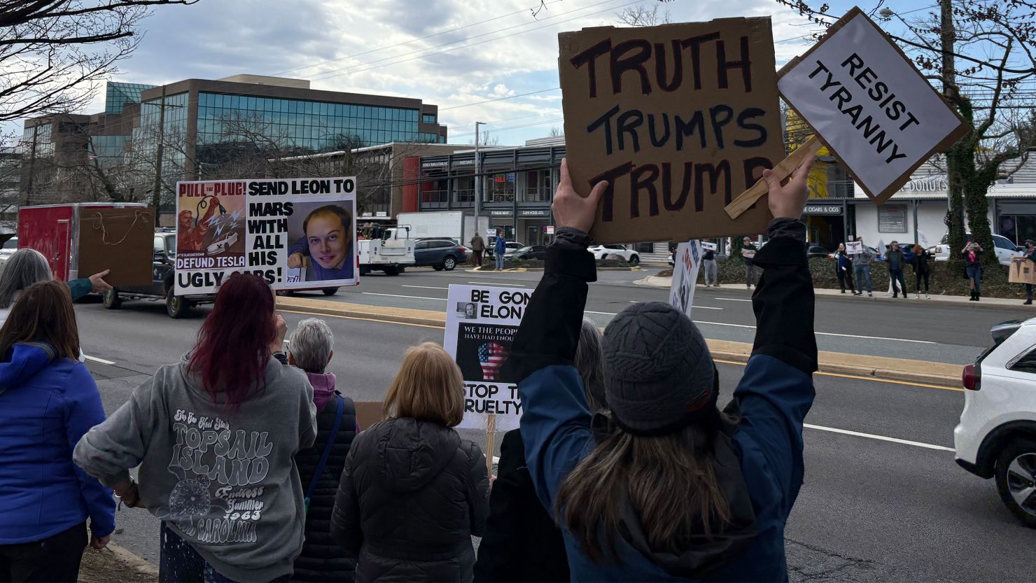 Demonstrators rally outside a Tesla showroom in Rockville, Maryland, on Saturday.