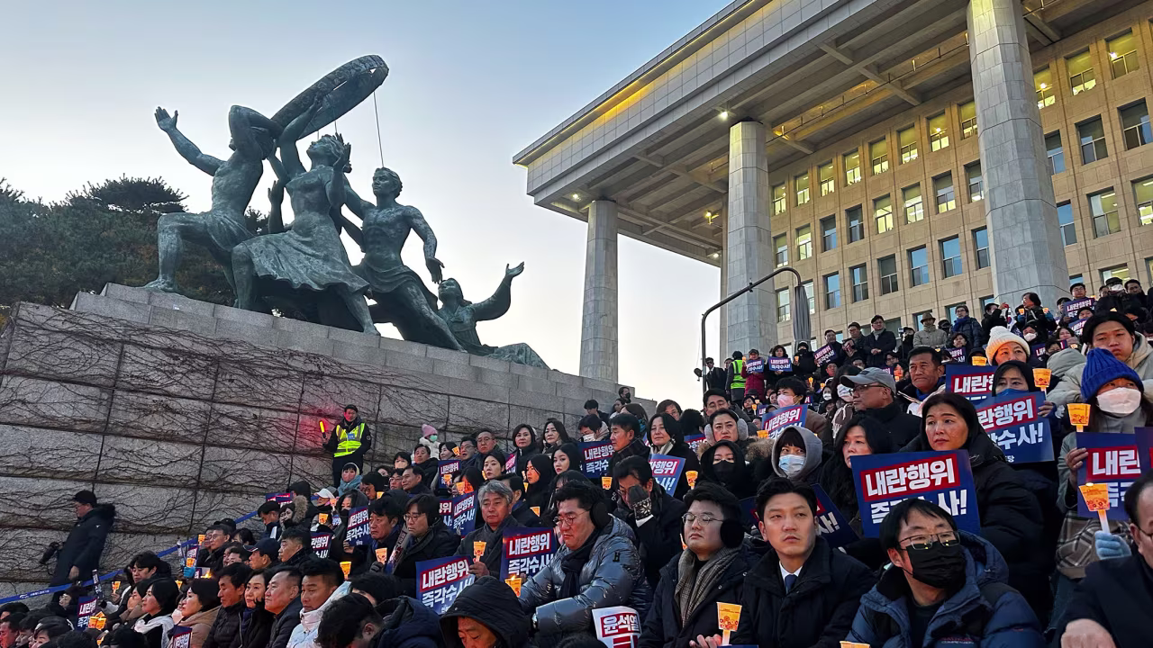 People attend a candlelight rally outside the National Assembly on December 4.
