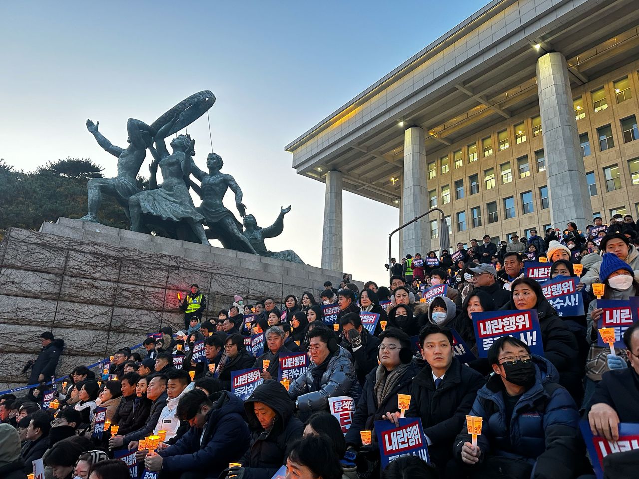 People attend a candlelight rally outside the National Assembly on December 4.