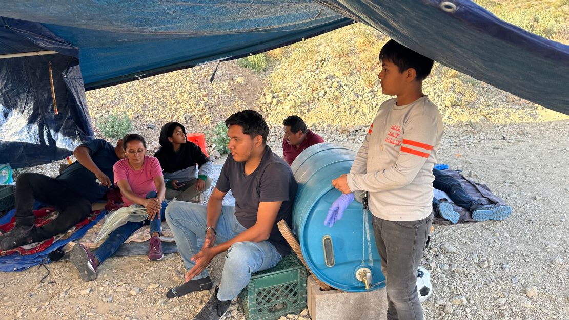 A family fleeing political threats waits to be apprehended after crossing the US-Mexico border into Arizona.