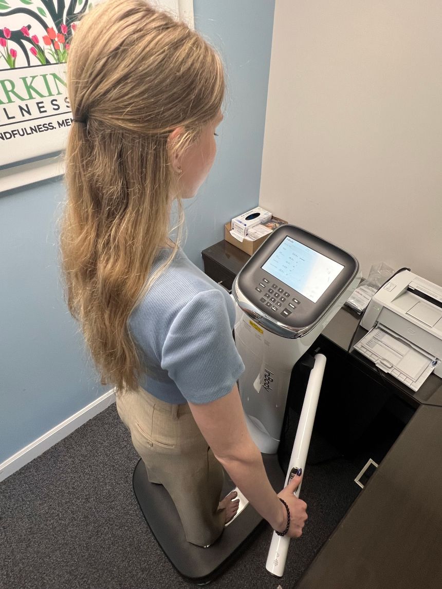 A mild electric current is sent through the body via the feet and thumbs on this bioelectrical impedance analysis machine.
