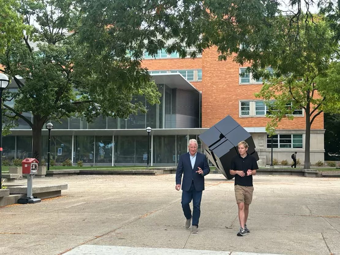 University of Michigan student Max Scheske walks with John King on campus in Ann Arbor, Michigan.